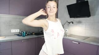 EmmaBacker - cute housewife in the kitchen dancing with her clothes on and shy to undress.