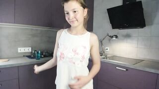 EmmaBacker - cute housewife in the kitchen dancing with her clothes on and shy to undress.