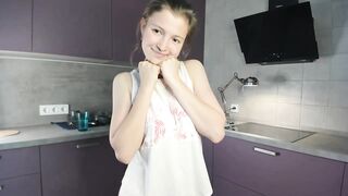 EmmaBacker - cute housewife in the kitchen dancing with her clothes on and shy to undress.