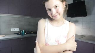 EmmaBacker - cute housewife in the kitchen dancing with her clothes on and shy to undress.