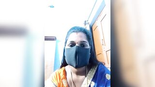 Hydcouple - Indian woman in a mask communicating on camera