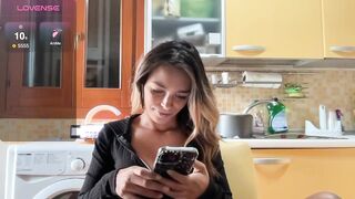 elisabettina02 - Young housewife having a nice chat in her kitchen.