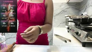 Sizzling__ZAARA -Housewife in a dress showing how she cooks.